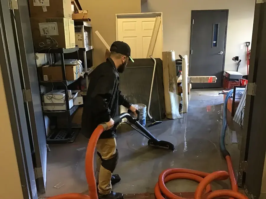 Technician extracting standing water from a floor in a La Grange, IL home